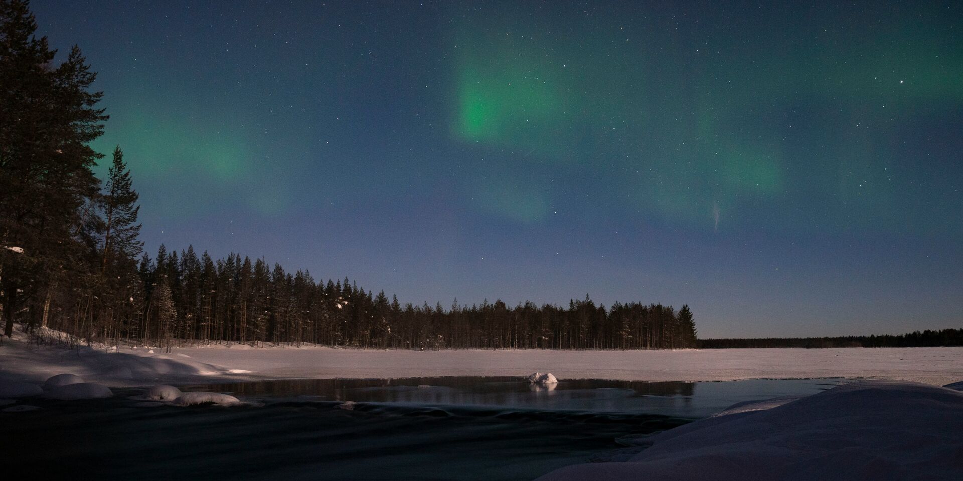 Northern lights over Finnish Lapland forest